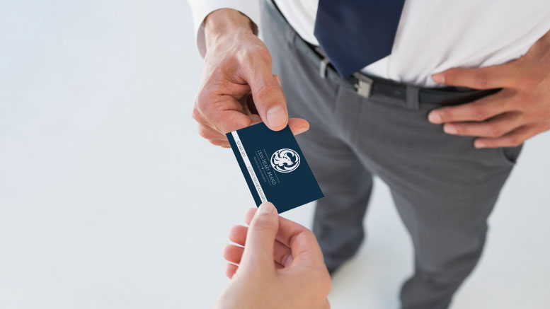 Bring your business cards in trade shows for networking opportunities. Entrepreneur giving his business card.